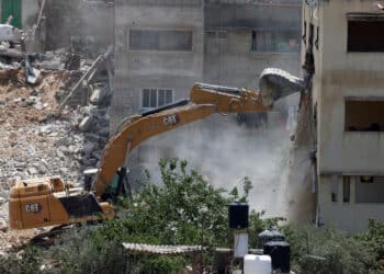 An Israeli military bulldozer demolishes a home at the Nur Shams Palestinian refugee camp in the Israeli occupied West Bank on June 23.