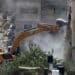 An Israeli military bulldozer demolishes a home at the Nur Shams Palestinian refugee camp in the Israeli occupied West Bank on June 23.