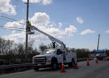 A utility truck repairs power lines following Hurricane Ian in Matlacha, Florida, US, on Wednesday, Oct. 5, 2022. President Biden and Governor DeSantis have feuded over political issues, including migrants, but are coordinating on assistance for Floridians hit by a hurricane Biden's called "among the worst in the nation's history."