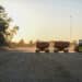 Carts of harvested soybeans are driven to a grain bin in Trenton, Missouri, US, on Thursday, Oct. 9, 2025. Soybean futures plunged, extending earlier losses, after US President Donald Trump threatened additional tariffs on Chinas goods and said there was no reason to meet with Chinese President Xi Jingping.
