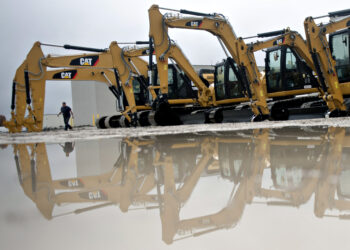 Caterpillar Inc. excavators sit on display at the Altorfer CAT dealership in Bettendorf, Iowa, U.S., on Friday, Oct. 19, 2012. Caterpillar Inc., the world's biggest construction and mining equipment maker, is scheduled to report quarterly earnings on Oct. 22.