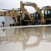 Caterpillar Inc. excavators sit on display at the Altorfer CAT dealership in Bettendorf, Iowa, U.S., on Friday, Oct. 19, 2012. Caterpillar Inc., the world's biggest construction and mining equipment maker, is scheduled to report quarterly earnings on Oct. 22.