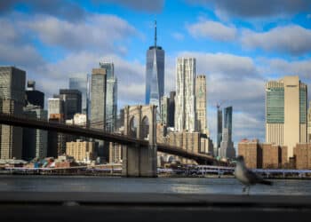 The Brooklyn Bridge and One World Trade Center along the Manhattan skyline in New York, US, on Tuesday, Dec. 30, 2025. New York City is staring down a $10 billion budget gap next fiscal year, reflecting slowing tax collections and uncertainty over federal funding streams.