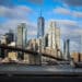 The Brooklyn Bridge and One World Trade Center along the Manhattan skyline in New York, US, on Tuesday, Dec. 30, 2025. New York City is staring down a $10 billion budget gap next fiscal year, reflecting slowing tax collections and uncertainty over federal funding streams.