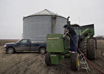 Michlig Energy driver Jake Gould delivers diesel fuel to a John Deere & Co. tractor in Manlius, Illinois, U.S., on Wednesday, Dec. 10, 2014. Gasoline supplies rose 8.2 million barrels to 216.8 million in the week ended Dec. 5, the biggest gain since the week ended Sept. 21, 2001. Inventories of distillate fuel, a category that includes diesel and heating oil, climbed 5.58 million to 121.8 million, the biggest increase since January