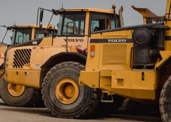 Volvo dump trucks in a lot during a Ritchie Bros heavy equipment auction in Bolton, Ontario, Canada, on Tuesday, May 9, 2023. Ritchie Bros Auctioneers Inc., a Canadian firm that sells heavy equipment at auctions around North America, struck an agreement in November to buy IAA, which sells damaged and written-off vehicles.
