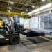 A worker drives a forklift at the Eos Energy Enterprises Inc. manufacturing facility in Turtle Creek, Pennsylvania, US, on Tuesday, May 27, 2025. Eos Energy, whose stock has surged more than 720% over the past year, has signed an initial pact with a large-scale developer of data centers as soaring power usage boosts demand for batteries.