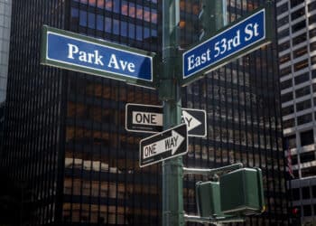 Street signs for Park Ave and East 53rd Street in front of the Seagram Building, which houses Blue Owl offices, in New York, US, on Wednesday, April 8, 2026. The outlook on the flagship fund of private credit giant Blue Owl Capital Inc. was cut to negative by Moody's Ratings, the latest sign of mounting strains in an industry stung by investors rushing to pull their money from funds aimed at retail buyers.