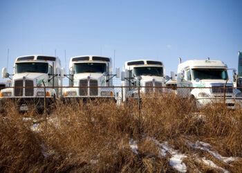 Arrow Trucking Co. tractors are stored on a lot near a Freightliner dealership in Tulsa, Oklahoma, U.S., on Monday, Jan. 4, 2010. Arrow Trucking Co., the 61-year-old Tulsa-based flatbed carrier, suspended operations on Dec. 22, 2009, laying off employees and stranding scores of drivers by cancelling fuel credit cards, Tulsa World reported. Federal Authorities later issued an emergency order to executives to retrieve company trucks and trailers from truck stops and parking areas around the country.