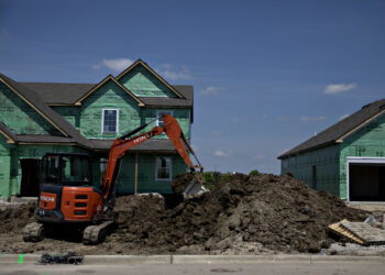 A worker operates a Hitachi Construction Machinery Co. excavator to dig a trench outside a new home under construction at a Lennar Corp. development in Montgomery, Illinois, U.S., on Wednesday, May 15, 2019. A stronger-than-expected increase in housing starts at the beginning of the second quarter bodes well for residential investment to make a contribution to GDP growth after five quarters of declines.