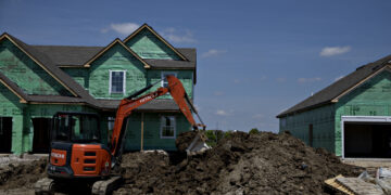 A worker operates a Hitachi Construction Machinery Co. excavator to dig a trench outside a new home under construction at a Lennar Corp. development in Montgomery, Illinois, U.S., on Wednesday, May 15, 2019. A stronger-than-expected increase in housing starts at the beginning of the second quarter bodes well for residential investment to make a contribution to GDP growth after five quarters of declines.