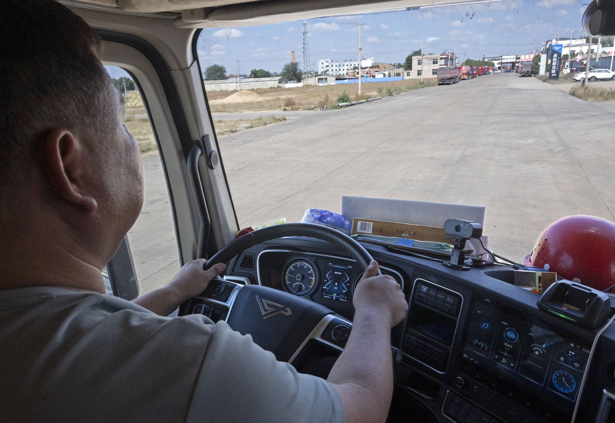 Trucker Li Bao at the wheel of his e-rig in Yulin.