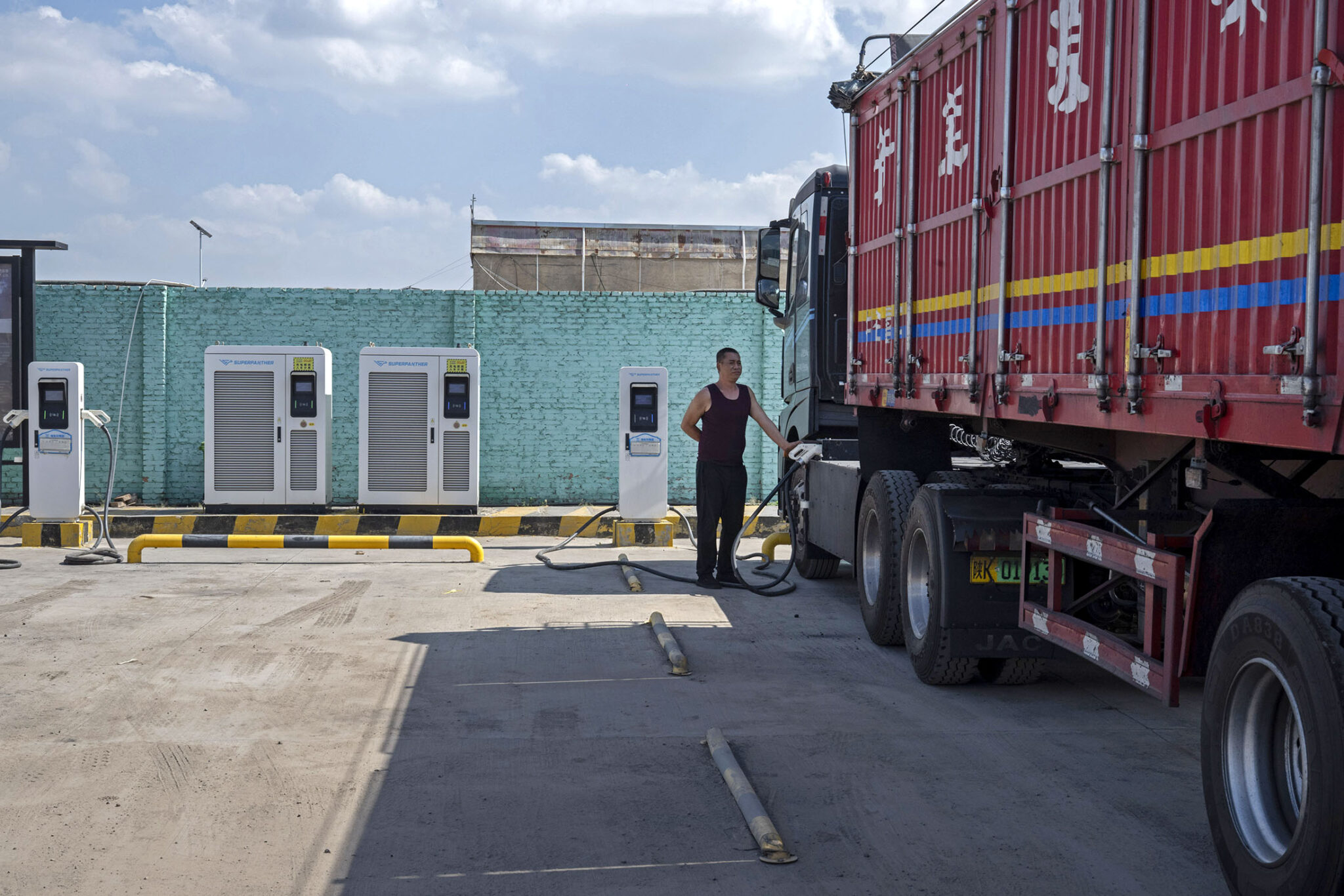 Qu Shaolong an electric truck driver during a charging demonstration at a charging station in Yulin, Shaanxi Province, China, on Monday, Sept. 21, 2026.